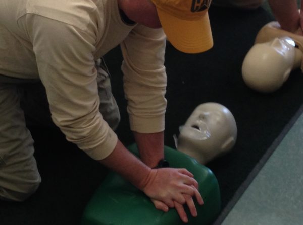 An Energy Services operations technician practices his CPR training.