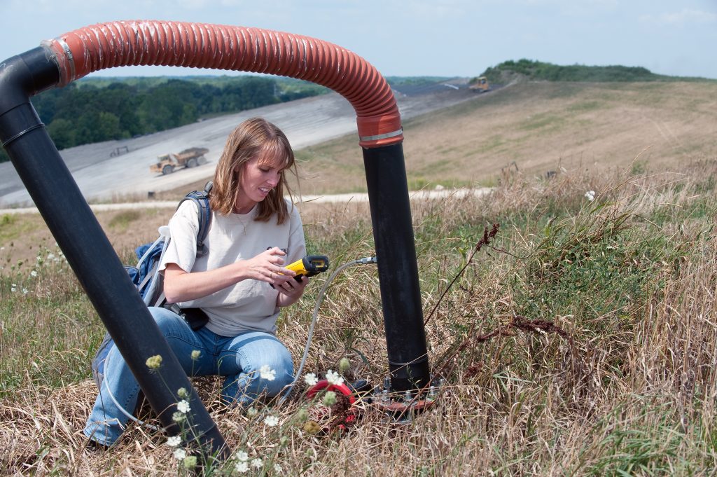 kim smelker with gas well and off-road truck in background