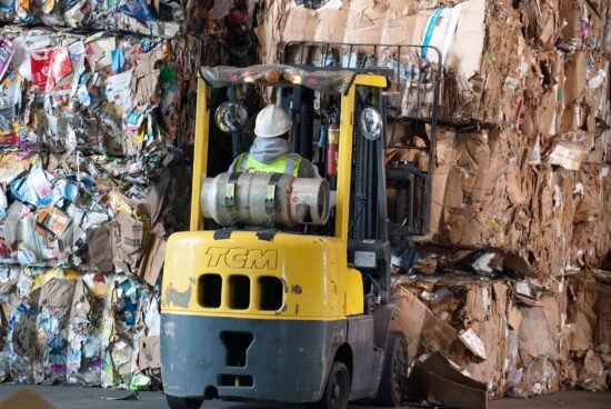 CD108-0107 2009 10 13 recycling worker moving bales with forktruck in recycling center